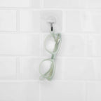 Misty Green Showerspecs anti-fog reading glasses hanging in the shower. 