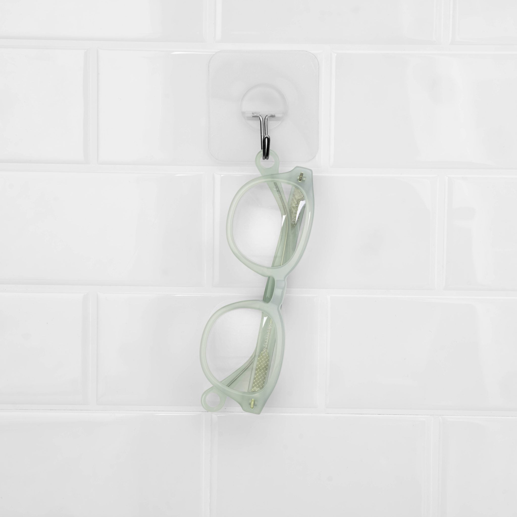 Misty Green Showerspecs anti-fog reading glasses hanging in the shower. 