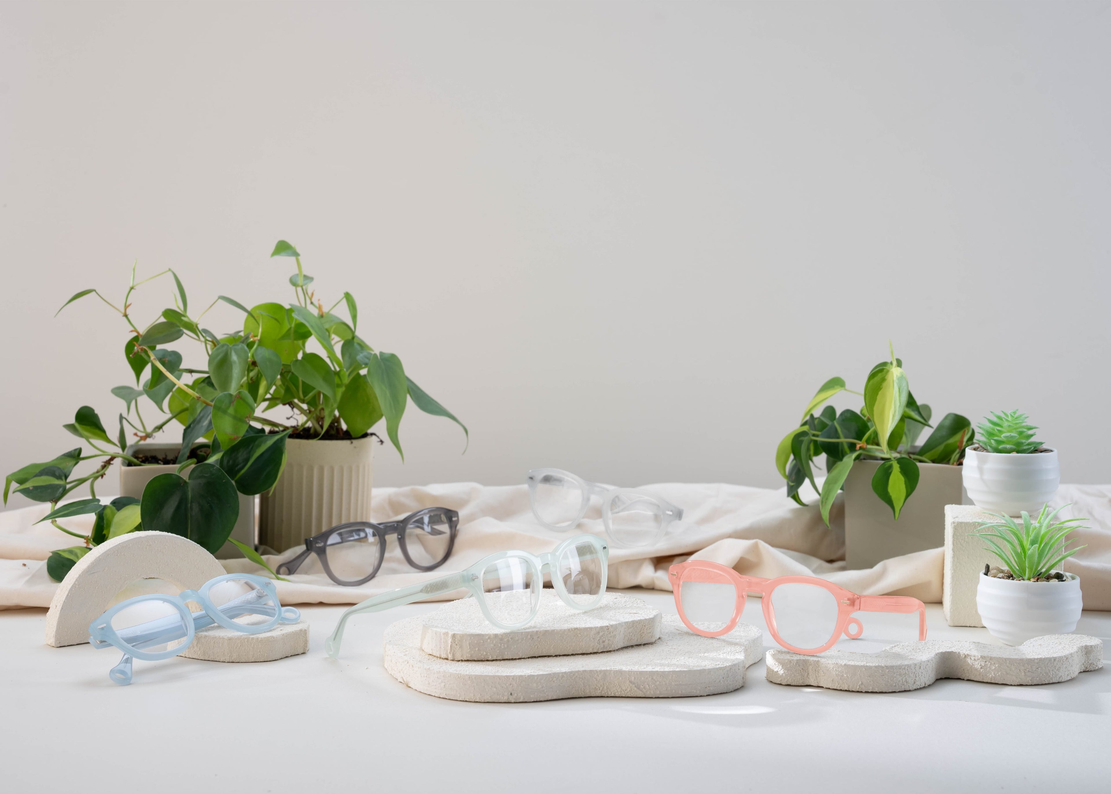 Showerspecs reading glasses displayed on a bathroom countertop.