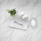 Showerspecs reading glasses on a bathroom countertop.