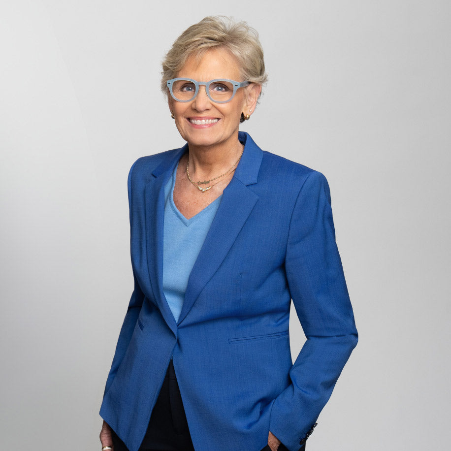 Showerspecs founder Donna Spurrier wearing blue Showerspecs reading glasses.