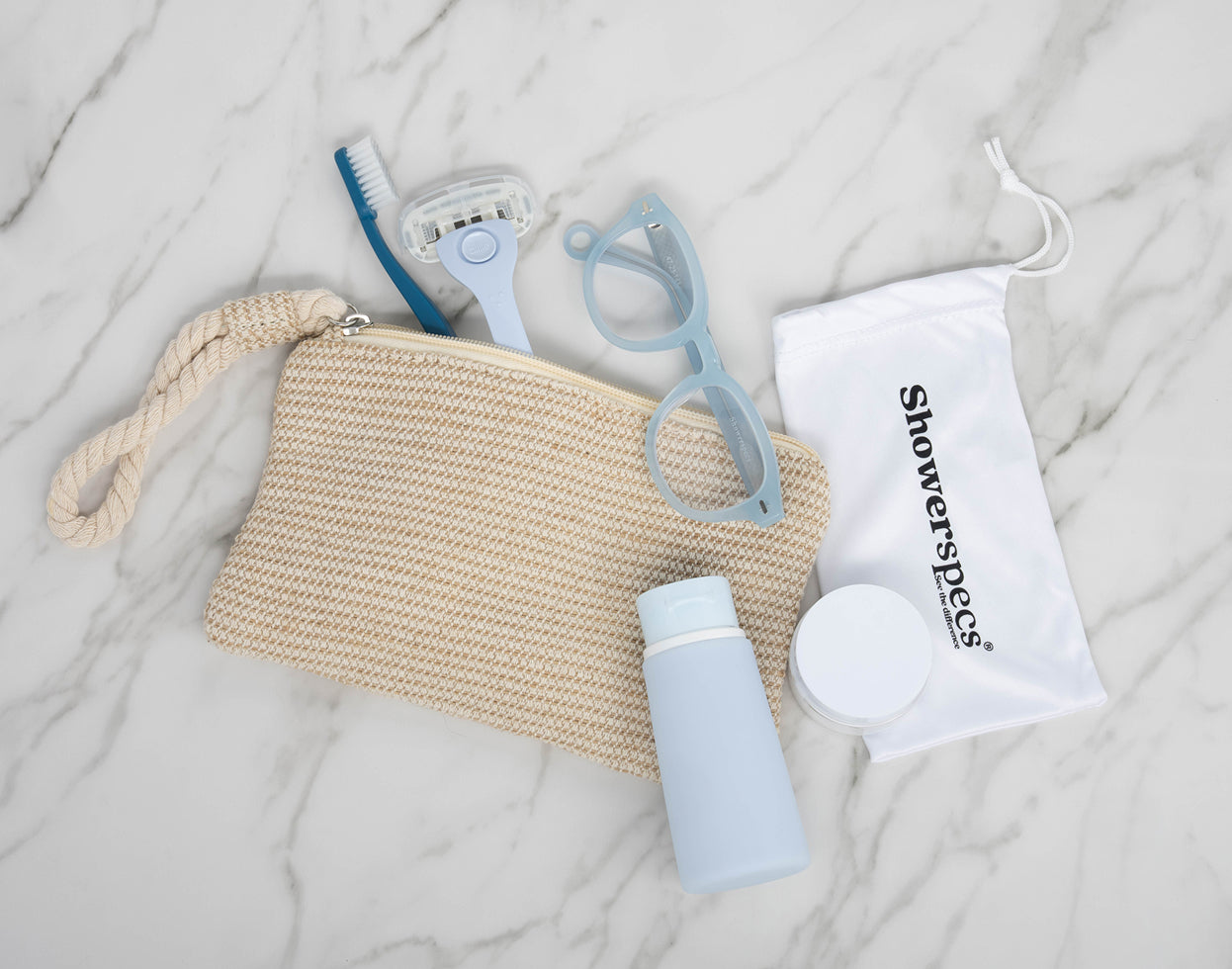 Pastel Blue Showerspecs reading glasses with travel toiletries and a storage pouch.