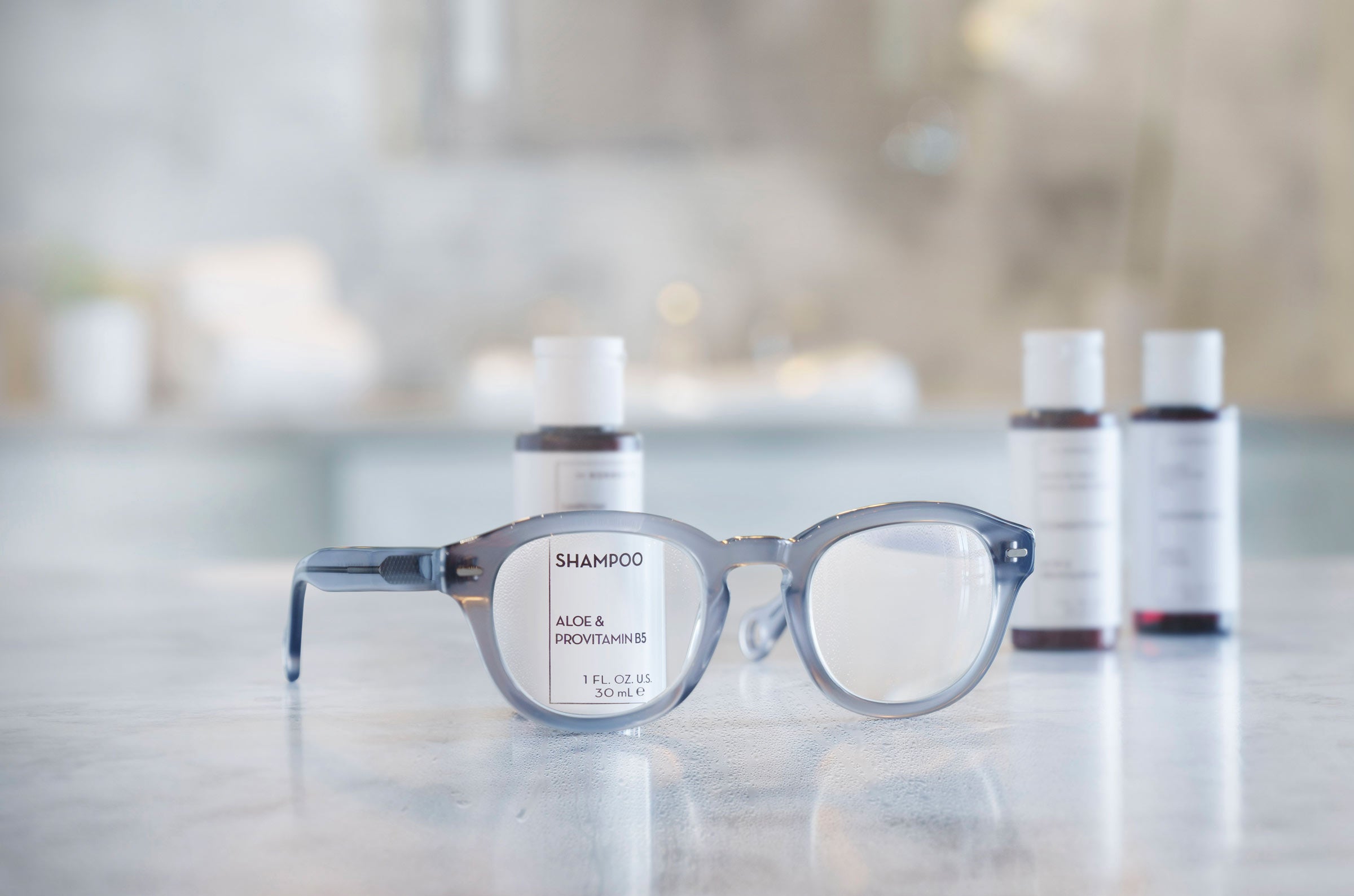Showerspecs anti-fog shower reading glasses with shampoo bottles in the background.