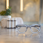 Stone Gray Showerspecs reading glasses on a spa countertop.