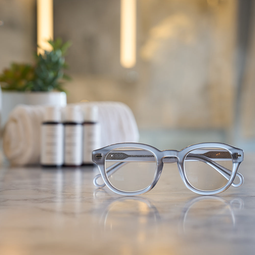 Stone Gray Showerspecs reading glasses on a spa countertop.