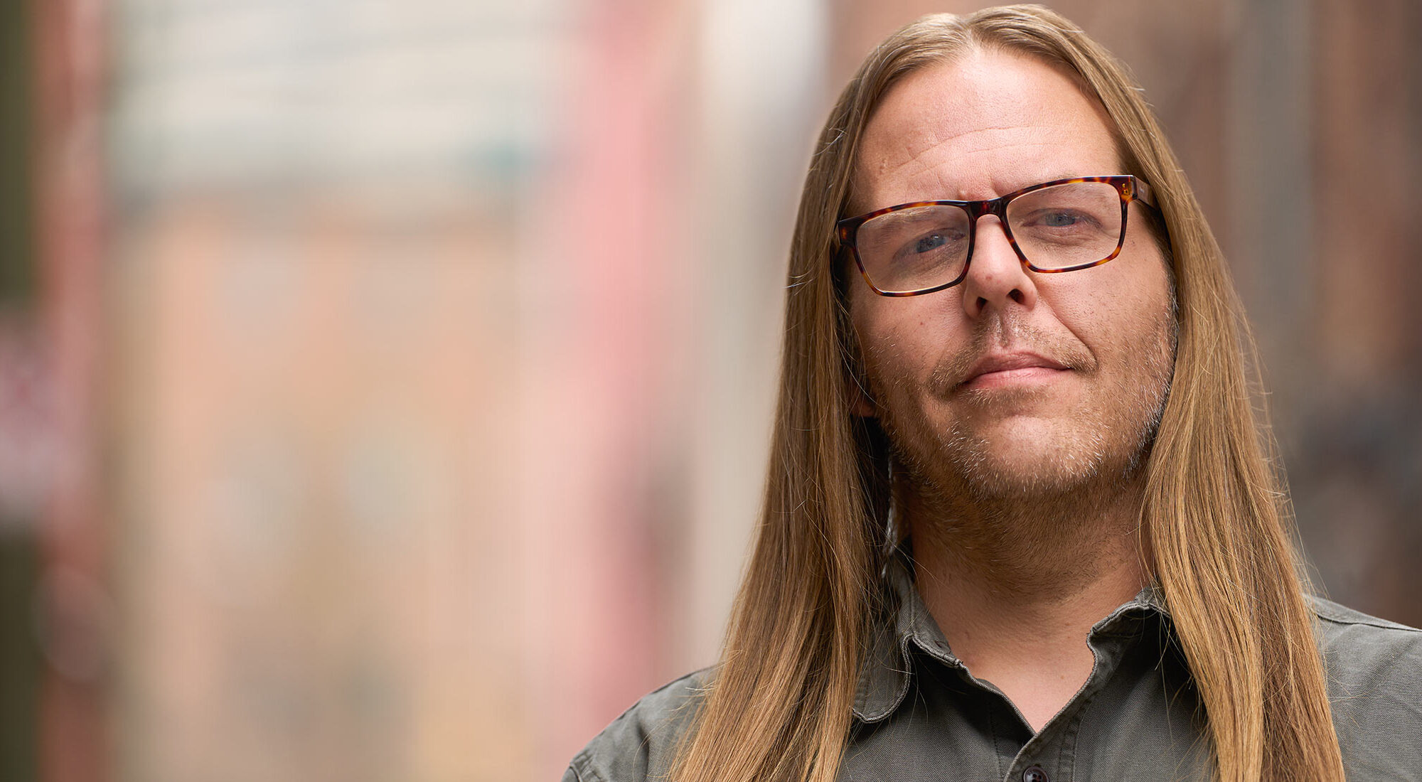 man with long hair wearing Clearspecs readers