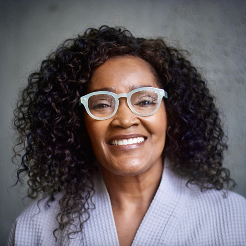 Smiling lady with green ShowerSpecs.